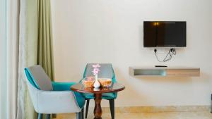 a room with two chairs and a table and a tv at Hotel Maenamla Namchi - yagi group in Namchi
