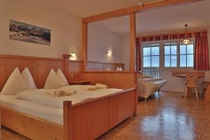 a bedroom with a large bed with a large mirror at Aparthotel Paradies in Flachau