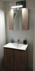 a bathroom with a sink and a mirror at Argyro's vintage House in Spílion