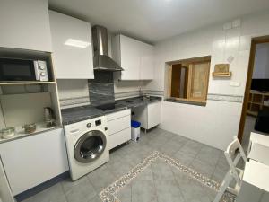 聖馬丁德拉維加的住宿－Casa Pumba，厨房配有洗衣机和洗衣机。