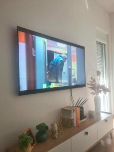 a flat screen tv hanging on a wall at Linda apartment in Ulcinj