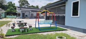 a playground in the backyard of a house at Tambun Hillview Cottage in Tambun
