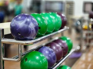 a row of green and purple bowling balls on display at TERENGGANU EQUESTRIAN RESORT (PADDOCK INN) in Kuala Terengganu