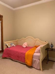 a pink dog laying on top of a bed at Luxury, modern, homely 4 bedroom house, close to city center, hospitals and shopping centers in Alexandria +20 photos