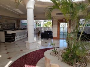 a lobby with columns and plants in a building at Palmore Top Luxury Resort First line of the Seaside in Eilat