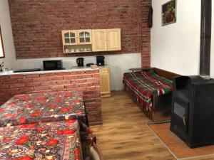 um quarto com duas camas e uma parede de tijolos em Лилянината къща em Kalofer