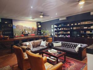 a living room with a couch and a table at Karongwe Portfolio- Shiduli Private Game Lodge in Karongwe Game Reserve