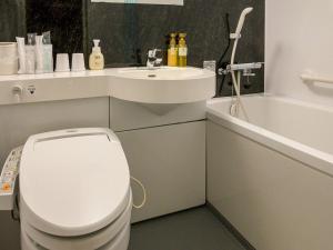 a white bathroom with a toilet and a sink at Tokai City Hotel - Vacation STAY 83890v in Tokai