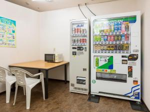 a refrigerator and a table in a room at Tokai City Hotel - Vacation STAY 83890v in Tokai