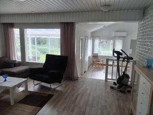 a living room with a elliptical machine in the middle of the room at Talo 140 m2 in Siilinjärvi