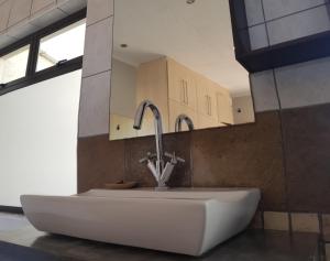 a white sink in a bathroom with a sink at Ietzie Longbeach in Swakopmund