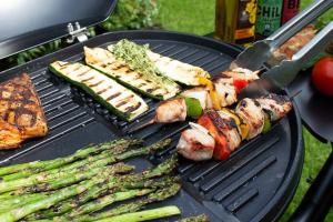 a grill with asparagus meat and vegetables on it at TinyHouse mit Terrasse und Garten in Heringhausen