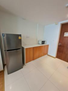 a kitchen with a stainless steel refrigerator and a counter at The Privilege Residence in Patong Beach