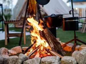 two pots and pans hanging over a campfire at AMAZING LIFESTYLE GLAMPING HOTEL - Vacation STAY 44042v in Nagahama