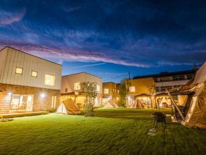 a group of buildings with tents in a yard at night at AMAZING LIFESTYLE GLAMPING HOTEL - Vacation STAY 44042v in Nagahama