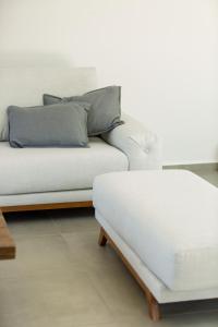 a white couch sitting in a living room at Vilana Exclusive Villas in Skouloúfia +52 photos