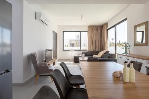 een woonkamer met een tafel en stoelen bij Nelia Panorama Villa in Protaras