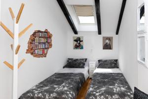 Zimmer mit 2 Betten und Bücherregal in der Unterkunft Sea house Lea in Novi Vinodolski
