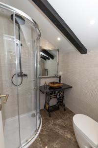 a bathroom with a shower and a toilet and a table at Sea house Lea in Novi Vinodolski +63 photos