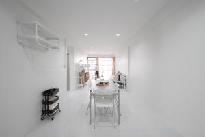 a white room with a table and chairs at Cozy home near city and air port in Chiang Mai