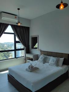 a bedroom with a large bed with a large window at Jesselton Quay by Miraton Lodge 2 in Kota Kinabalu