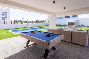 a pool table in the middle of a patio at Nelia Panorama Villa in Protaras