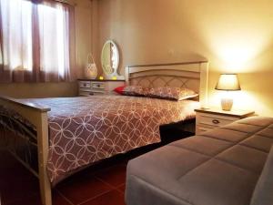 a bedroom with a large bed and a window at Villa Corali in Karfas