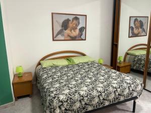 a bedroom with a bed and two side tables at Alloggio Turistico Casa Mafalda in Rome