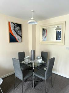 a dining room with a black table and chairs at Hatley Residencies in Dudley