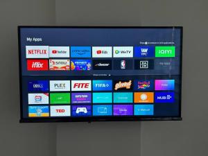 a television screen with a bunch of logos on it at Caishen Modern Affordable Apartelle 202 in Silang +3 photos