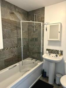 a bathroom with a tub and a sink and a shower at Hatley Residencies in Dudley