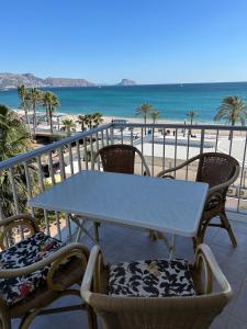 a table and chairs on a balcony overlooking the beach at Terraza Albir in Albir