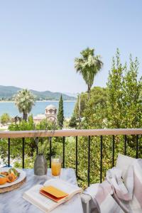 a table with a plate of fruit and a glass of orange juice at Liotopi in Olympiada