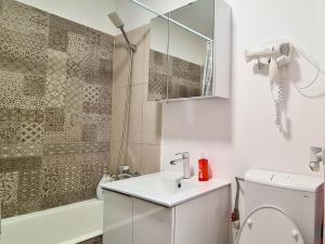 a bathroom with a sink and a toilet and a shower at Cozy Apartment- zona centrala in Bacău