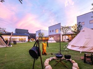a tent and a grill in a yard at AMAZING LIFESTYLE GLAMPING HOTEL - Vacation STAY 44030v in Nagahama