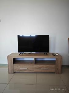 a wooden entertainment center with a flat screen tv on top at 1 Pacific FairPrice in Nadi