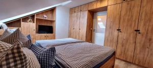 a bedroom with two beds and a television in it at Waldhotel am Turm 