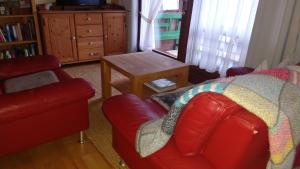 sala de estar con sofá rojo y mesa en Schöne Aussicht en Todtnau