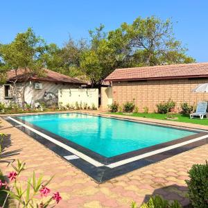 a swimming pool in front of a house at Vijay Vilas Heritage Resort in Lāeja