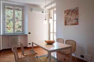 a dining room with a table and chairs at Gerbett Apartment with Terrace by Wonderful Italy in Como