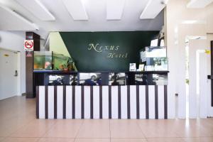 a store with a sign that reads nesris fund at Nexus Hotel in Melaka