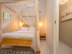 ein Schlafzimmer mit einem Himmelbett in der Unterkunft Monkeys Tail in Marloth Park