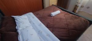 a white napkin sitting on top of a bed at Serene Studios Kamakis Eastern bypass in Ruiru