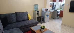 a living room with a couch and a kitchen at Serene Studios Kamakis Eastern bypass in Ruiru +7 photos