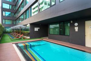 a swimming pool in front of a building at VIC 3 Bangkok Hotel in Bangkok +81 photos