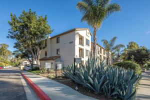 a white building with palm trees in front of a street at La Jolla 1br w gym wd pool nr bars shops SAN-44 in San Diego