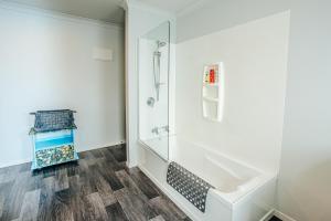 a bathroom with a shower and a sink at Sunrise Accommodation in Whakatane