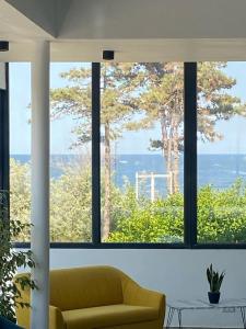 a living room with a couch and a large window at Hotel Gloria in Eforie Sud