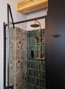 a bathroom with a shower with green tiles at Sankakkei 2 - Lewy Brzeg Narwi in Burlaki