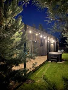 a house with a ping pong table in a yard at night at Sankakkei 2 - Lewy Brzeg Narwi in Burlaki